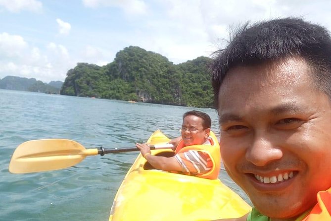 Ha Long Bay Six Hours Trip Kayaking & Swimming on Beach - Surprising Cave: stalagmites, sea-life shapes, and a cool break